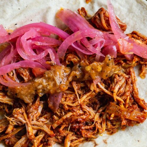 inside the taco cochinita pibil with pickled onions